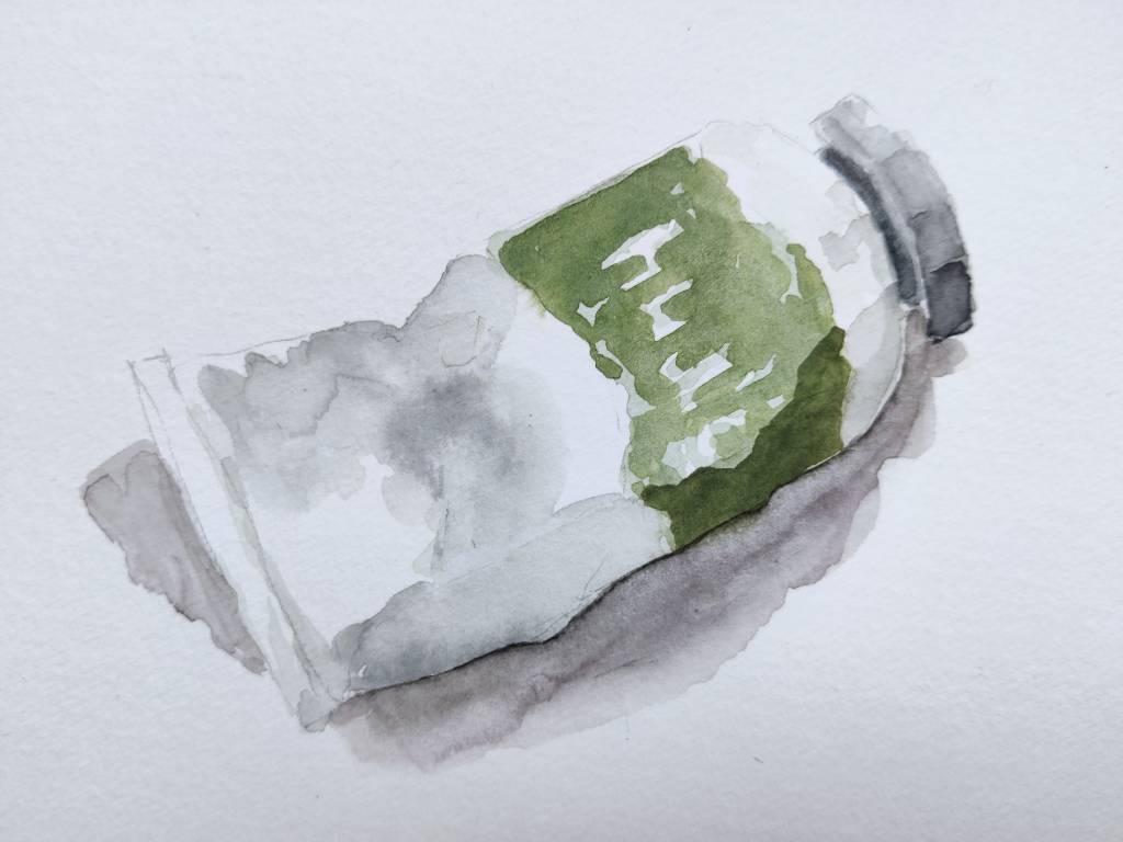 Dessin d'un tube de peinture verte. On peut deviner le mot "huile"