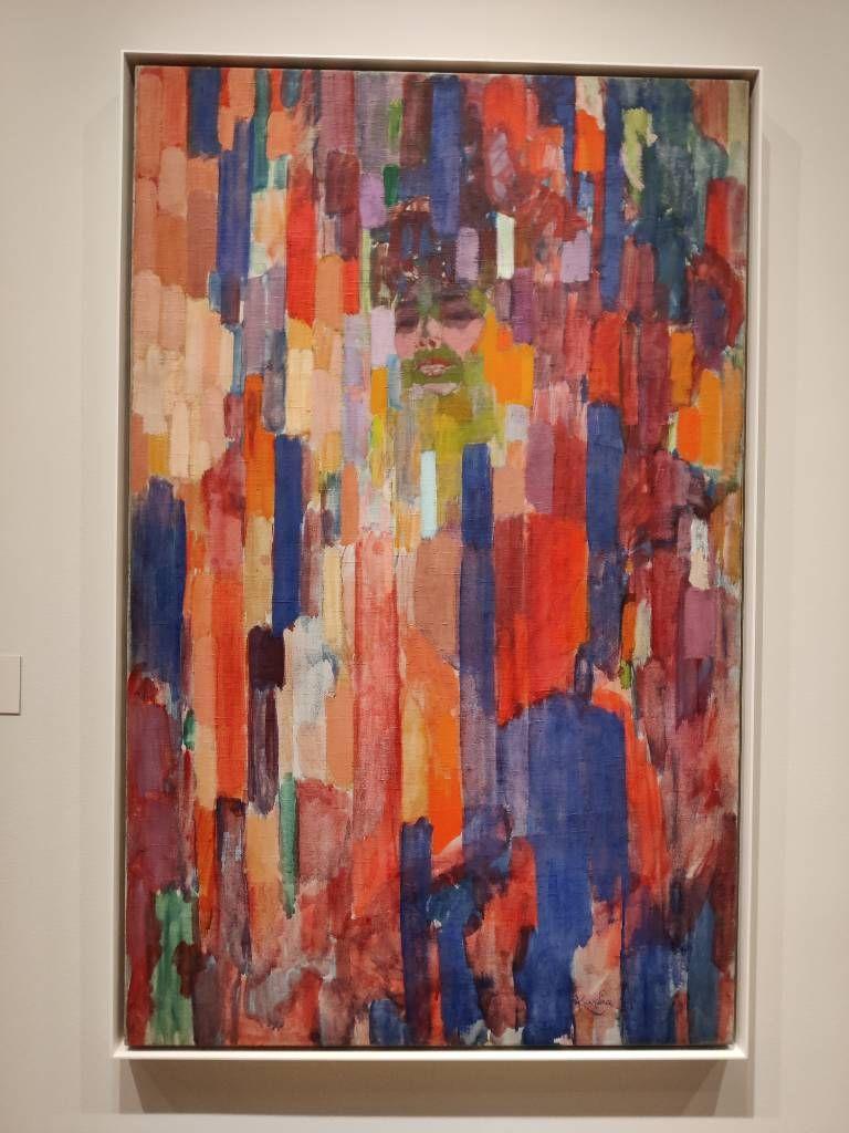 Traces de couleurs différentes au sein desquelles apparaît un visage