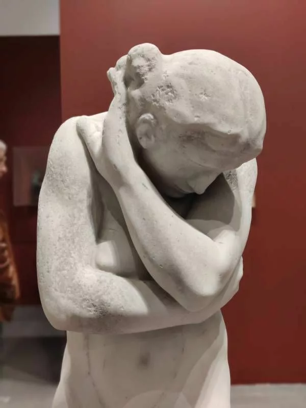 Sculpture représentant une femme cachant sa tête dans son bras