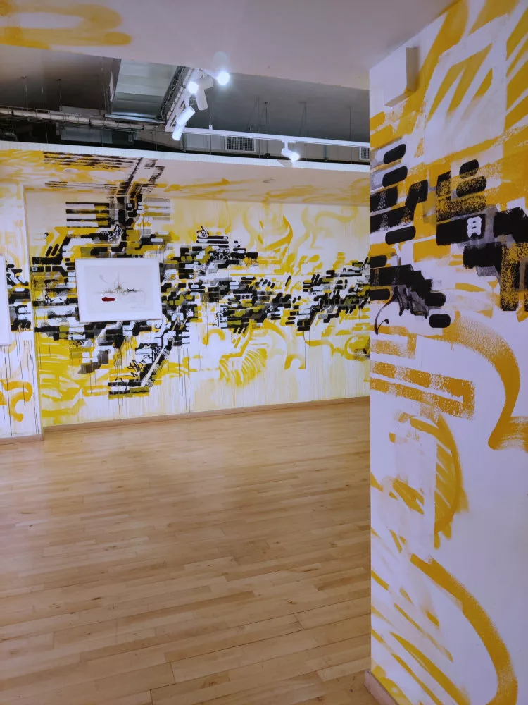 Différents pans de mur avec un même motif jaune et noir les recouvrant, y compris des pans de plafond