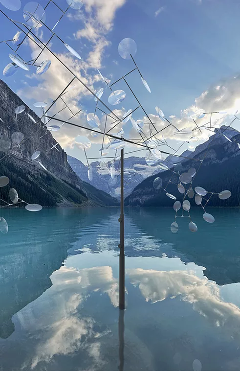 Installation sur un lac de montagne (du moins, ça y ressemble) faite de disques semi transparents ou miroir fixés sur des tiges et mus par le vent