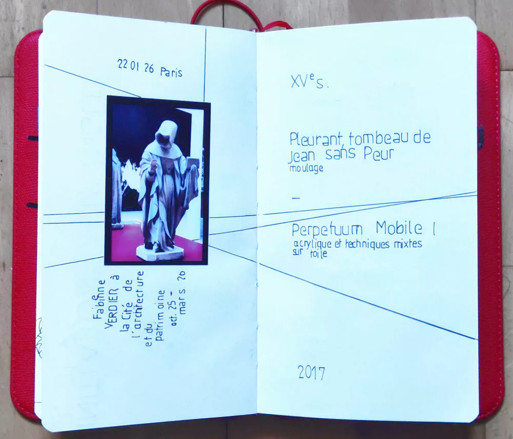 Une double page d'un carnet avec une photo d'une sculpture de moine derrière lequel on aperçoit une toile) collée à partir de laquelle partent des lignes droites reprenant la perspective de la photo et du texte fait au normographe indiquant date, lieu et titre des œuvres