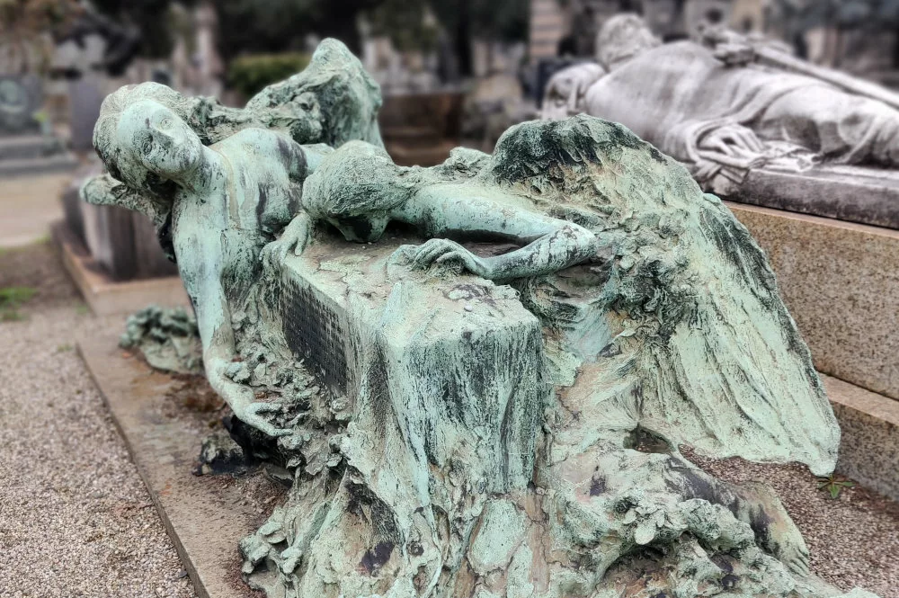 Tombe avec une sculpture représentant des anges penchés sur la tombe