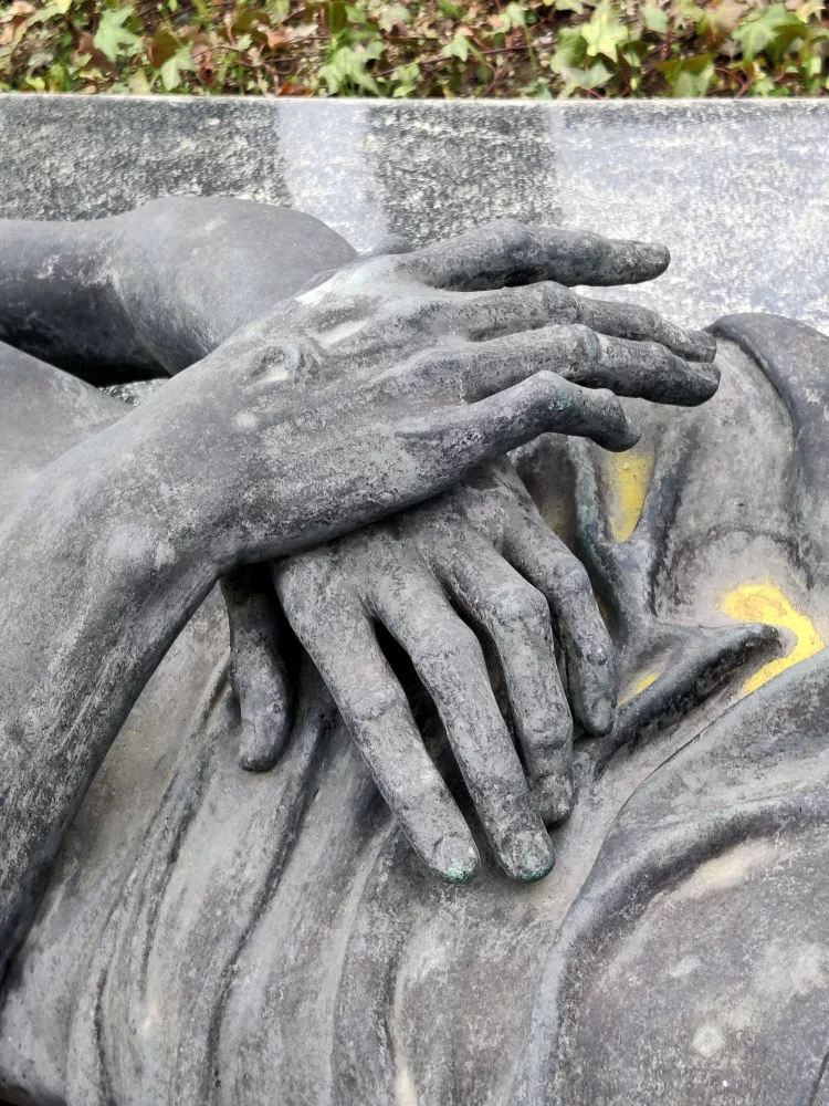 Gros plan sur une sculpture représentant des mains posées l'une sur l'autre